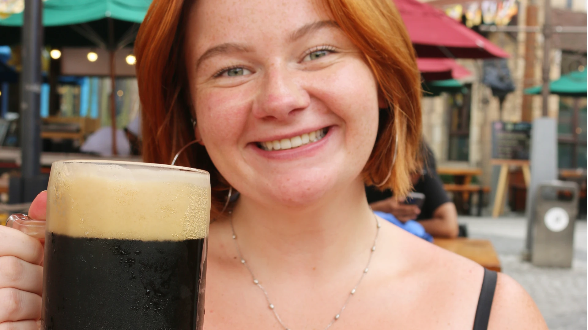 Eloise drinking a big stein of dark ale